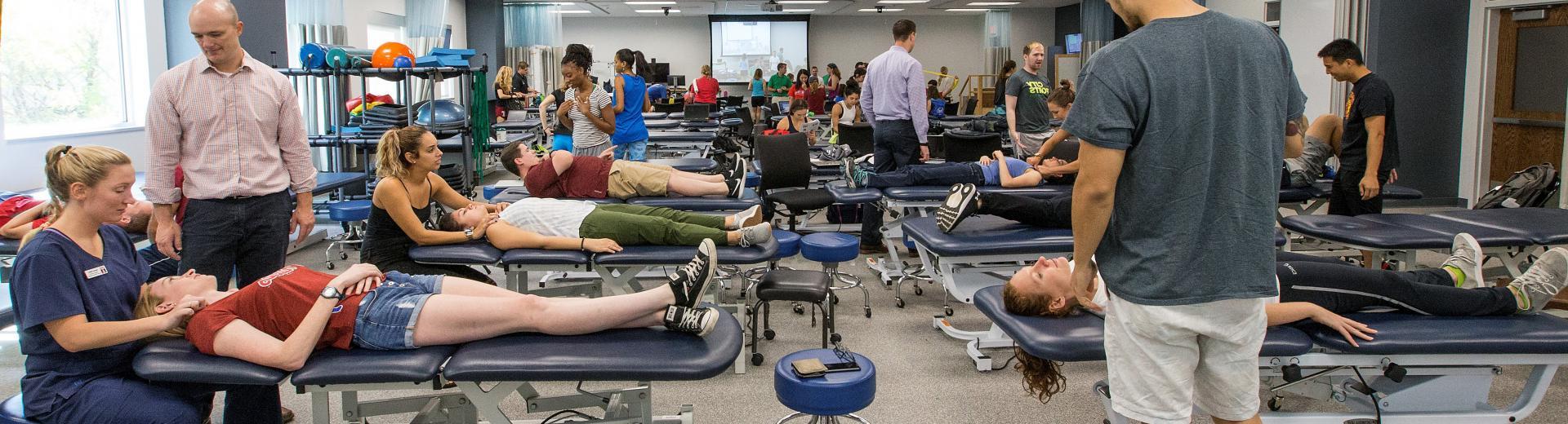 Physical therapy students practicing on patients