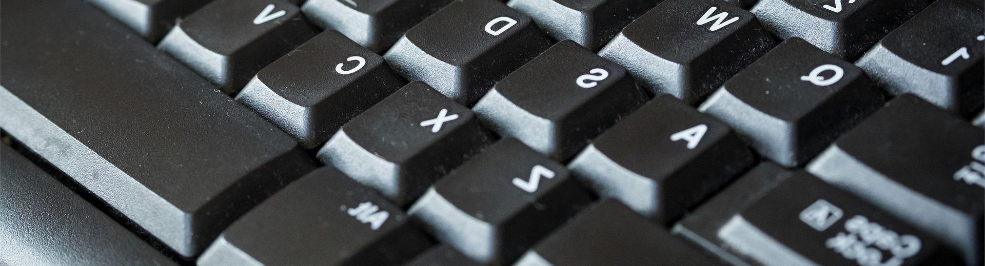 A close-up look of a grey computer keyboard.