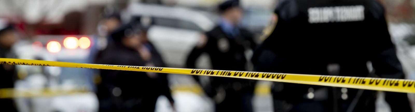 Police cordon off a crime scene using yellow "police tape."