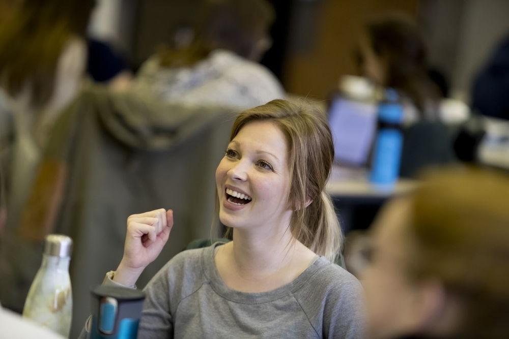 An occupational therapy student laughs during class.